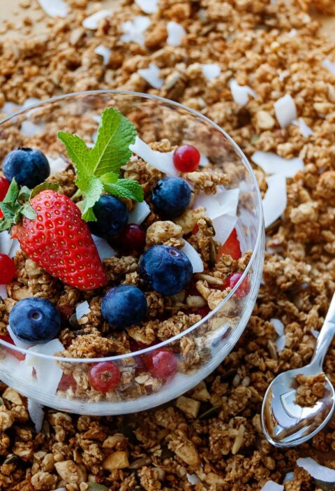 A top view of a healthy granola breakfast with fresh berries and yogurt in București.