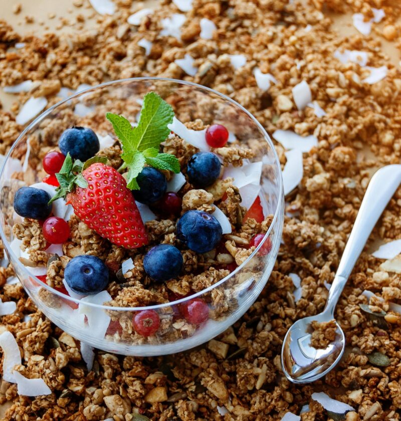 A top view of a healthy granola breakfast with fresh berries and yogurt in București.
