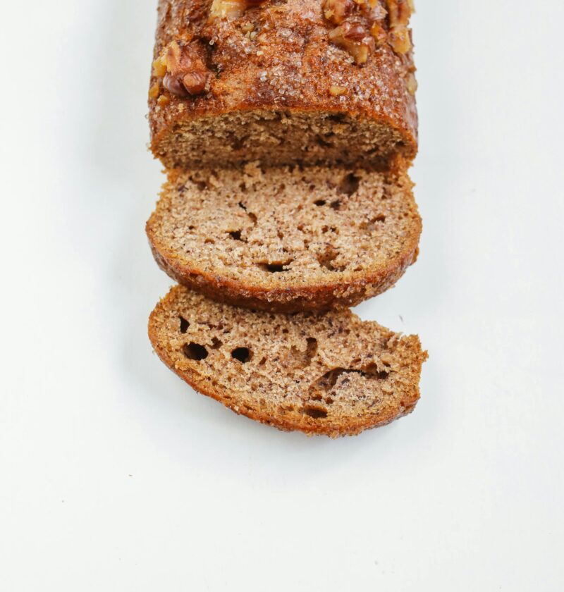 Close-up of sliced banana bread on a white surface. Perfect for food photography.