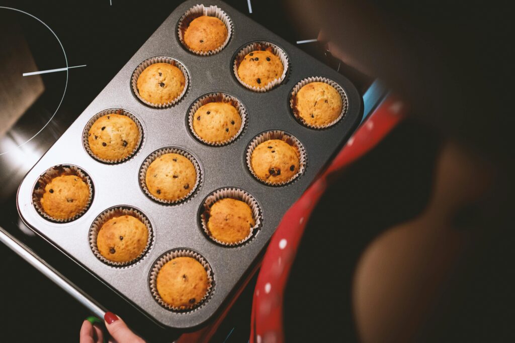 pexels-photo-245554-245554 A tray of freshly baked chocolate chip muffins taken out of the oven.