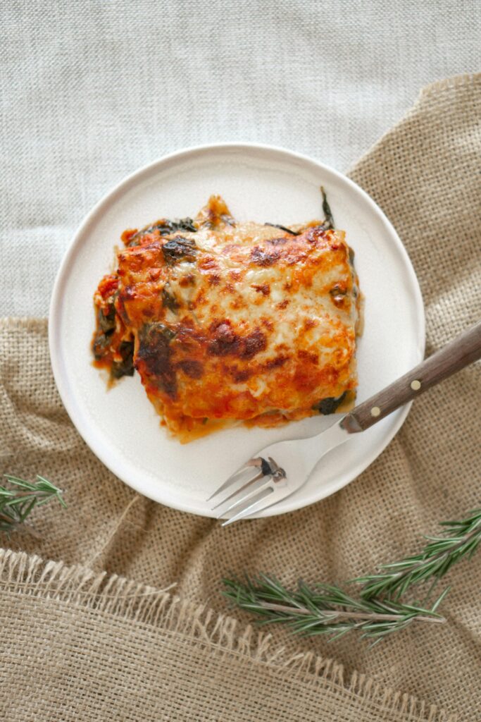 Top view of a classic homemade lasagna served on a rustic plate.