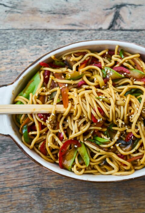 Tasty stir-fried noodles with fresh vegetables and sesame seeds, perfect for a healthy meal.