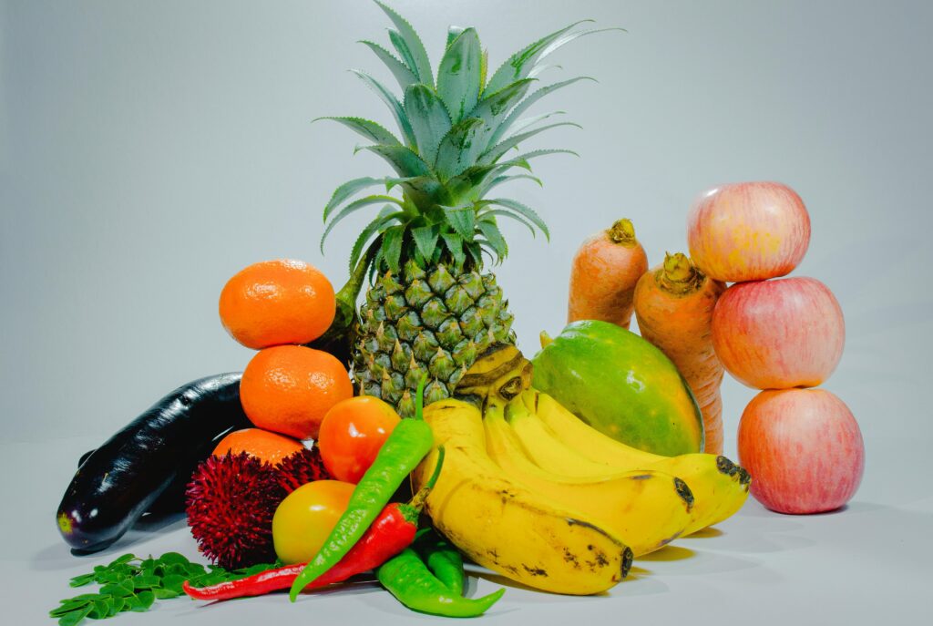 A colorful display of fresh tropical fruits and vegetables for healthy eating.